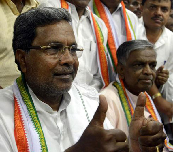 Karnataka Chief Minister-designate K. Siddaramaiah flashes thumbs up after the Congress Legislature Party meeting at KPCC office in Bangalore on Friday. 
