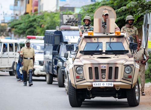 An armoured police car patrols during a curfew following violence in the city due to the Cauvery water sharing dispute with neighbouring state Tamil Nadu, at Sunkadakatte in Bangalore on Tuesday. -Photo/ Ranju P
