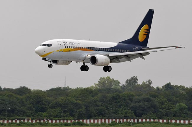 A Jet Airways passenger aircraft prepares to land at the airport in the western Indian city of Ahmedabad August 12, 2013. Jet recently won a key regulatory approval for its deal to sell a 24 percent stake to Etihad for $379 million, which will be the biggest foreign investment in the Indian civil aviation sector after ownership rules were relaxed. The companies, which need some more approvals, are yet to close the deal. REUTERS/Amit Dave (INDIA - Tags: TRANSPORT BUSINESS)