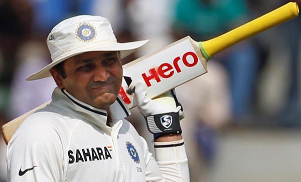 India's Virender Sehwag walks off the field after being dismissed by West Indies' Devendra Bishoo during the fifth day of their third and final test cricket match in Mumbai November 26, 2011. REUTERS/Vivek Prakash (INDIA - Tags: SPORT CRICKET)