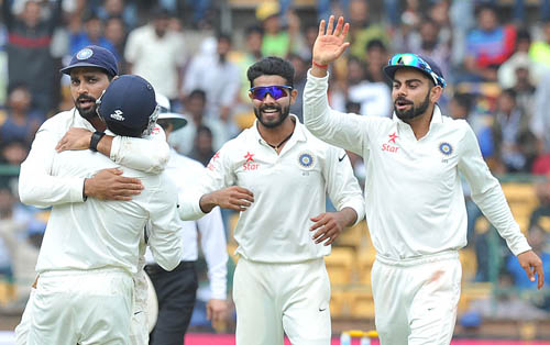 India's wicket keeper Vruddhiman Saha being congratulated by Murali Vijay, Ravindra Jadeja and Virat Kolhi after taking the catch of South Africa's AB de Villiers of Ravindra Jadeja in the 1st innings of the 1st test match on the 1st day play at Chinnaswamy Stadium in Bengaluru on Saturday. Photo Srikanta Sharma R.