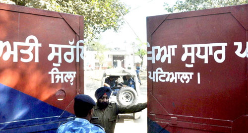 RPT--Nabha: Rapid Action Force men at Nabha Central Jail, which was stormed by armed men who helped in escaping five terrorists including Khalistan Liberation Front chief Harminder Mintoo, in Nabha on Sunday. PTI Photo(STORY DEL2, 28) (PTI11_27_2016_000101B)